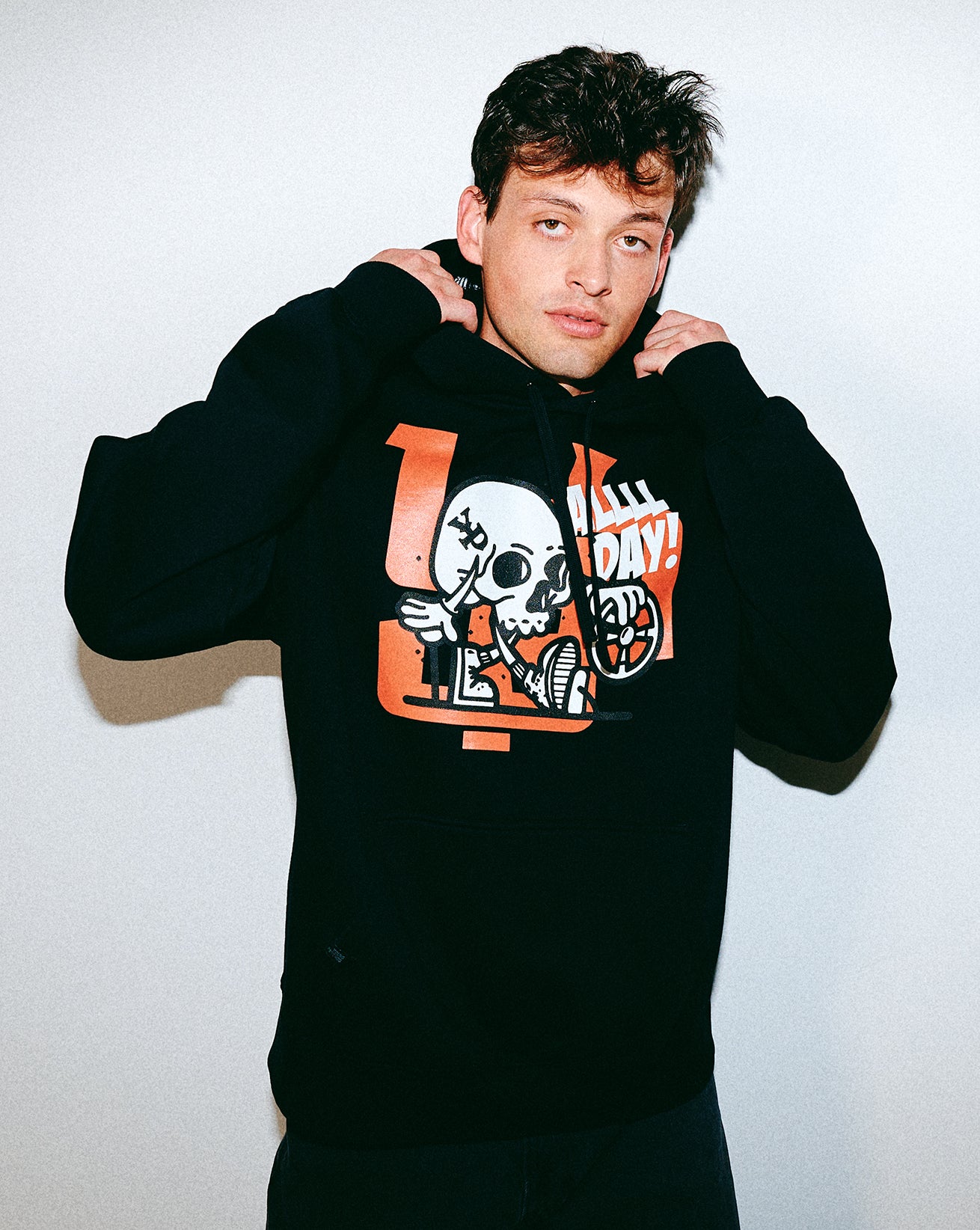 Person wearing a black hoodie with Young Psychos graphic design on a white background