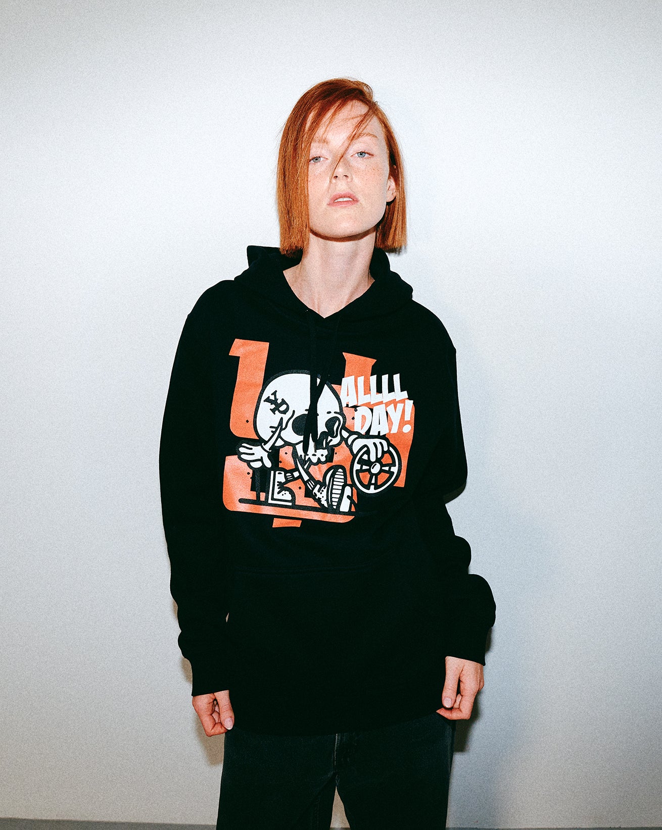 Person wearing a black hoodie with Young Psychos graphic design on a plain background